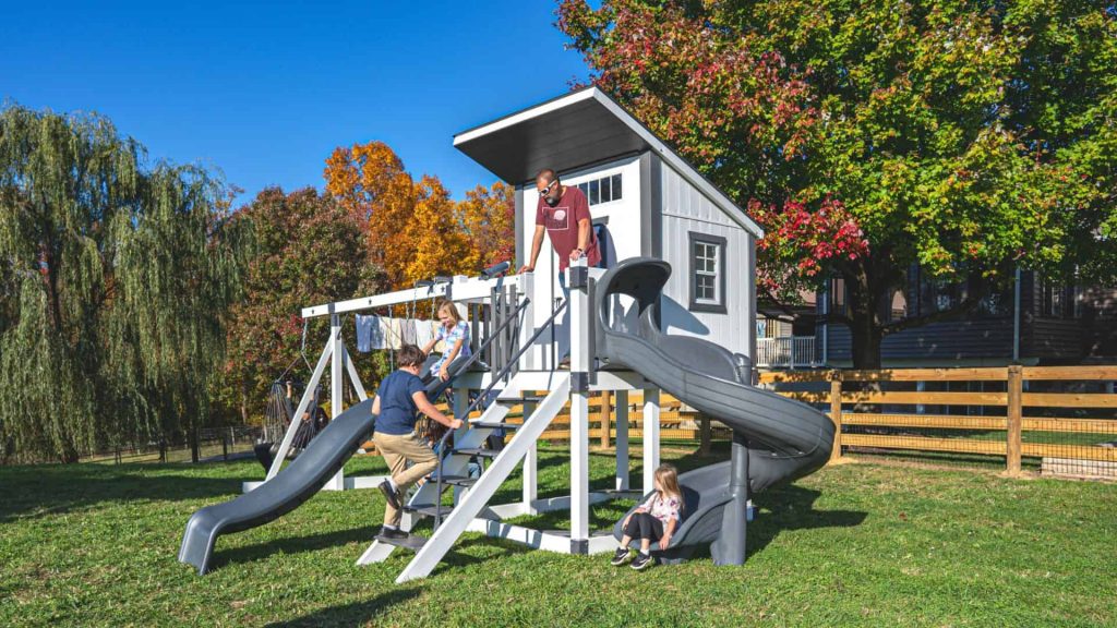 children climbing and sliding down gray and white star gazer vinyl swing set for sale